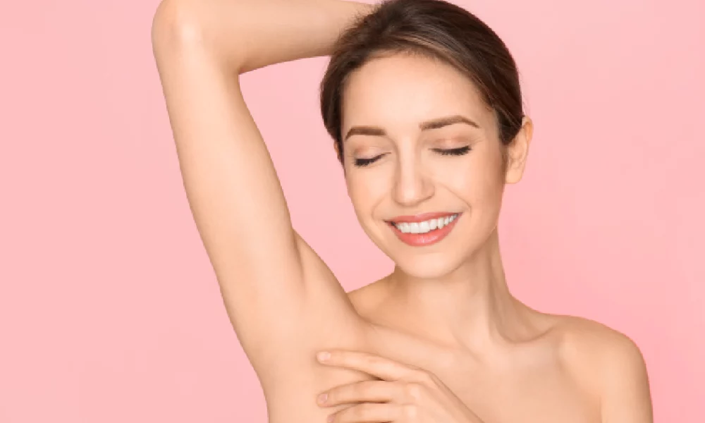 Smiling woman showing smooth underarm skin after treatment, representing successful laser hair removal in Spring, TX for long-lasting results.